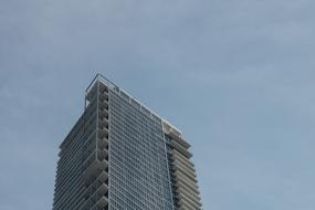 skyscraper under the clouds at dusk