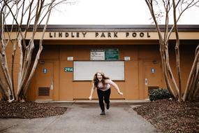 runner on road near Building Structure and Trees