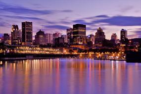 Beautiful shore of the city, with the colorful lights, under the colorful and beautiful sky, with the clouds, in the evening