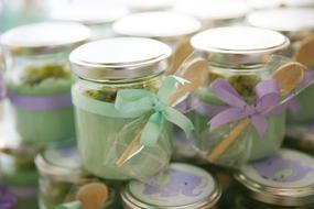 stack of small jars with wooden spoons