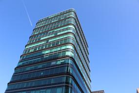 Shiny building, with the windows, in sunlight and shadow, in Amsterdam, Netherlands, under the blue sky