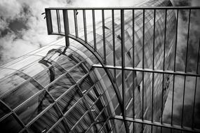 black and white photo of a round skyscraper with a glass facade