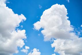 fluffy tall cumulus Clouds in Blue Sky