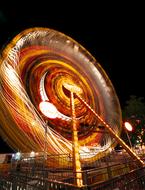 illuminated Ferris Wheel in Amusement Park at night, long exposure