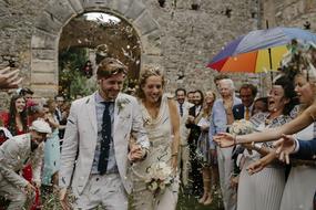 wedding couple walking through crowd