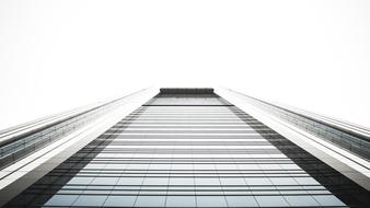 photo of a skyscraper going into the white sky