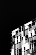 black and white photo of a building at night