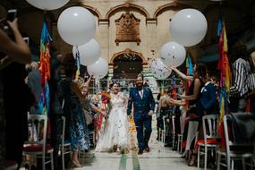 wedding couple walking through crowd of people