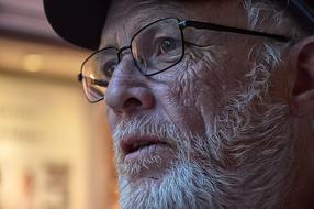 photo portrait of an elderly man with a beard in glasses
