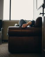 man on the leather sofa in the room