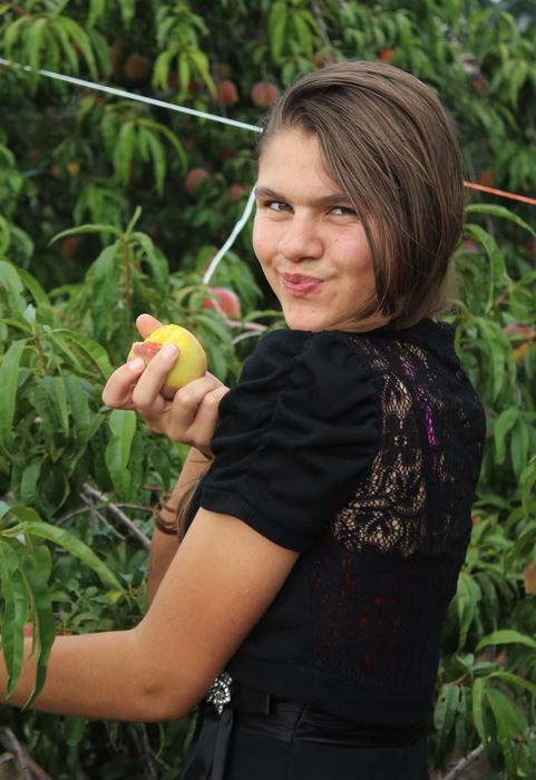 funny Girl with peach in hand