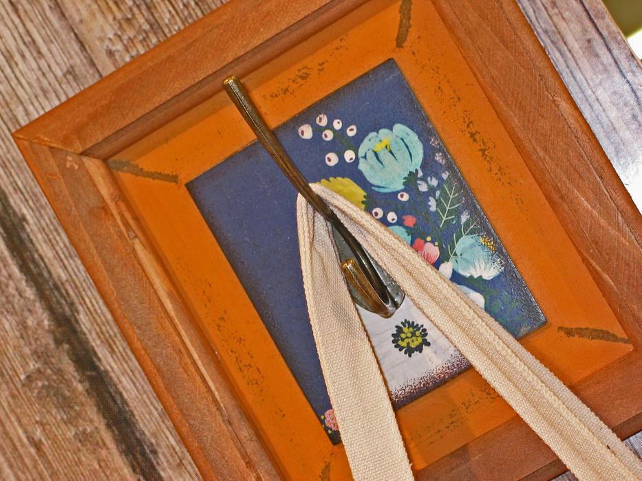 Beautiful and colorful painting with the coat hook with the bag