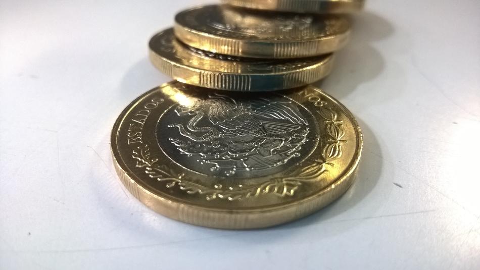 Close-up of the colorful, shiny Mexican Peso coins with images