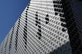 Grey, shiny structure of the architecture, under the blue sky