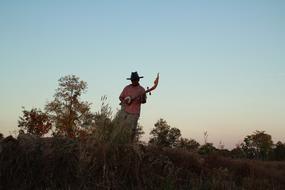 photo of a musician in a field in Thailand