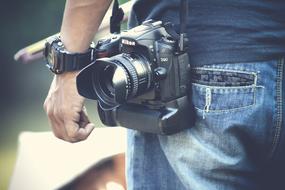 Black camera hanging on a man's shoulder