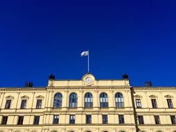 Beautiful Karlstad Courthouse, with the flag, in Karlstad, Sweden, under the blue sky