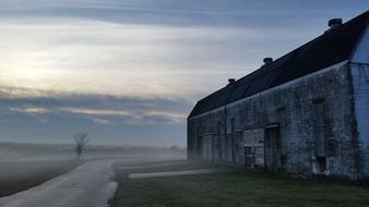 old building near a dirt road at dusk