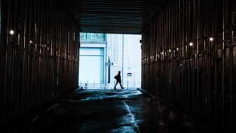 a lonely man walks near the tunnel