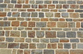 Close-up of the colorful stone wall of the church in Brittany, France