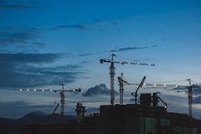 night sky above construction cranes