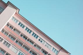 pink building facade on blue sky background