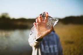 piece of ice in a manâs hand
