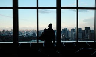 silhouette of a man in a building against the background of a cityscape