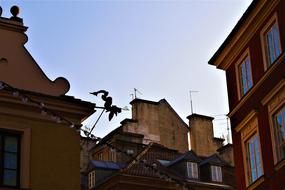 Dragon on the colorful and beautiful roof in Warsaw, Poland, at blue and white, gradient sky on background