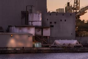 industrial structures near the water at dusk