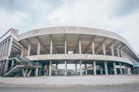 Empty semicircular building under cloudy sky