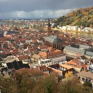 Beautiful and colorful cityscape of Heidelberg, Germany, with the castle, near the colorful mountain, under the clouds