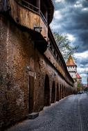 old fortress with wood covered passage on brick wall