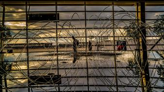 Metal wire fence near the beautiful water fountain