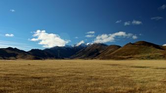 high mountains on the background of a dry field