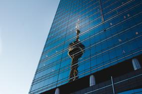 broadcasting tower reflection on blue glass Building