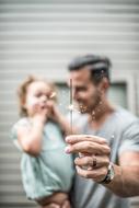 father and child enjoy the sparkler