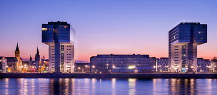 Beautiful cityscape with the coast with colorful lights at colorful sky background