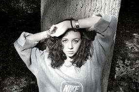 Black And White picture of Woman by the tree in park