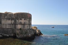 Beautiful coast of Dubrovnik with rocks at blue sky background in Croatia