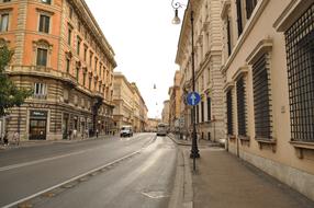 Beautiful landscape of the street of Rome, Italy, with the colorful buildings, cars, plants and people