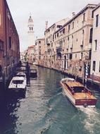 boats on the canal among buildings