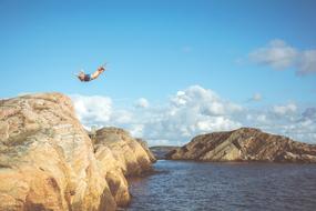 Man jumping cliff