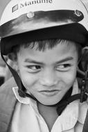 Child boy in helmet, black and white