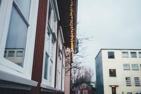 christmas lights over the windows of the house