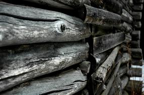 black and white photo of a log wall in a barn