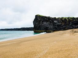 black stone with the sea and the beach