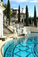 Beautiful landscape of the Hearst Castle with the green tree and turquoise pool. in California