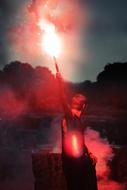 photo of a guy launching a signal fire