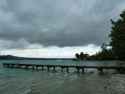 rain clouds over a wooden pier